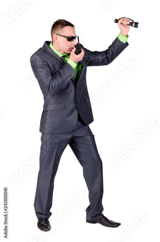 Security agent is talking on a portable walkie talkie radio station and using a flashlight isolated on white background.