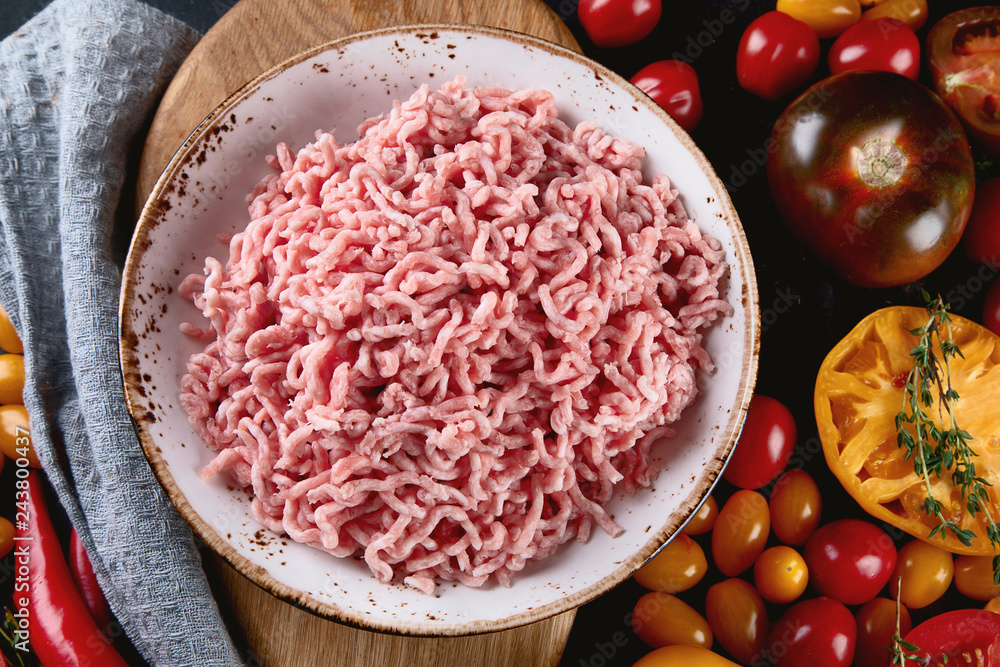 Ingredients for cooking - minced meat, tomatoes and spices. Ingredients for cooking - minced meat, tomatoes and spices.