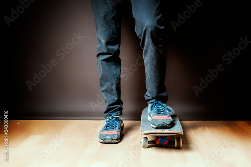 close up male with skateboard concept, on dark background f