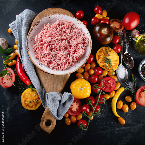Ingredients for cooking - minced meat, tomatoes and spices.
