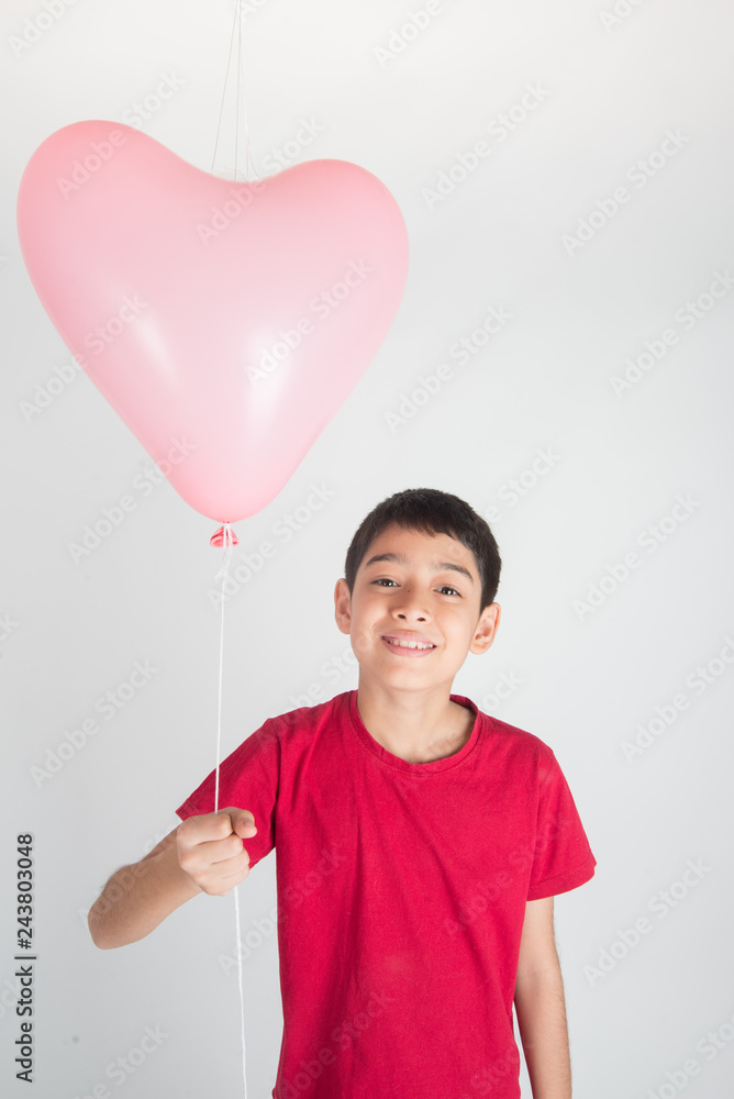 Boy sibling with balloon heart shape of love Boy sibling with balloon heart shape of love