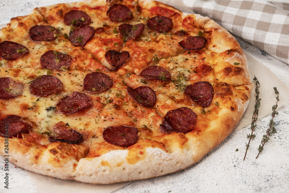 pizza with salami, ingredients, light background, close-up