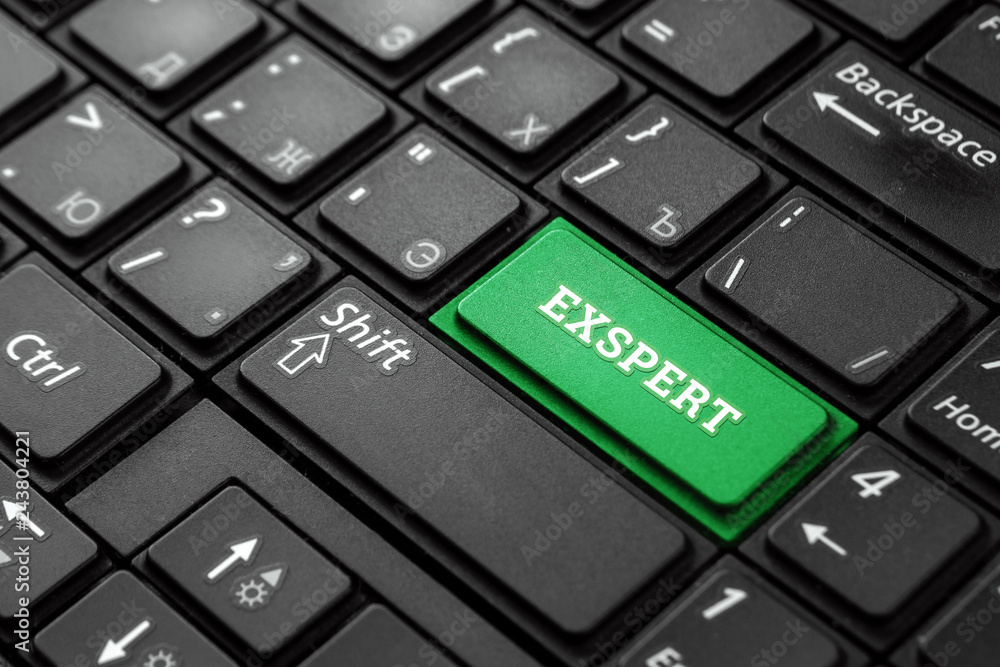 Close up green button with the word Expert, on a black keyboard. Creative background, copy space. Concept magic button, professional, connoisseur, professor. Close up green button with the word Expert, on a black keyboard. Creative background, copy space. Concept magic button, professional, connoisseur, professor.