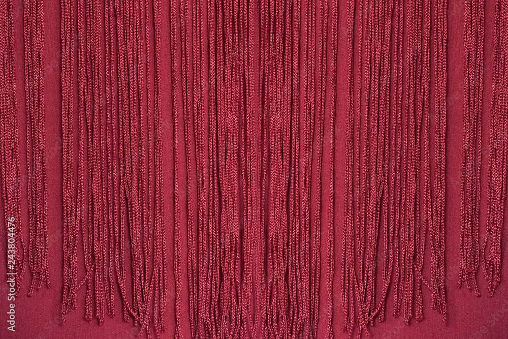 Fototapeta premium Maroon fabric with fringe. Close-up. Background