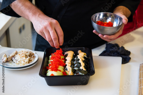 Chef making sushi in the bar photo