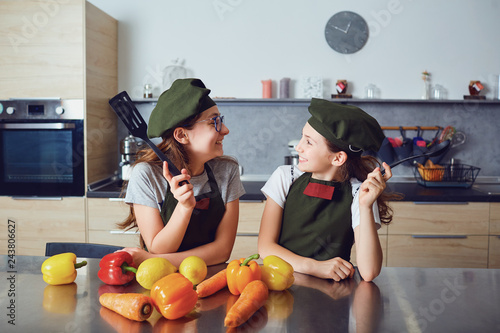 Girls children preparing cookies in the kitchen.