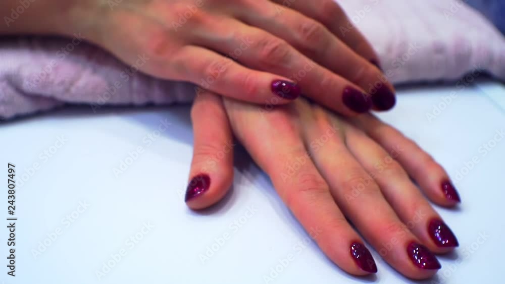 well-groomed hands of a young woman with a beautifully made modern bright manicure.nails painted bright red.close-up. well-groomed hands of a young woman with a beautifully made modern bright manicure.nails painted bright red.close-up.
