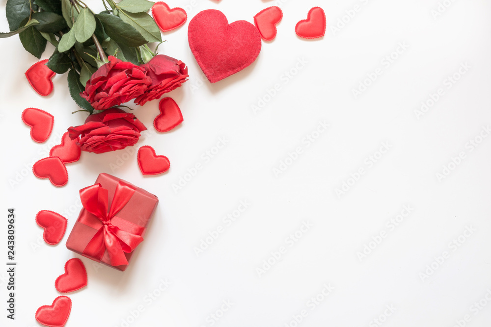 Valentine's day greeting card. Composition with gift, roses, red hearts on white. Top view. Copy space. Valentine's day greeting card. Composition with gift, roses, red hearts on white. Top view. Copy space.