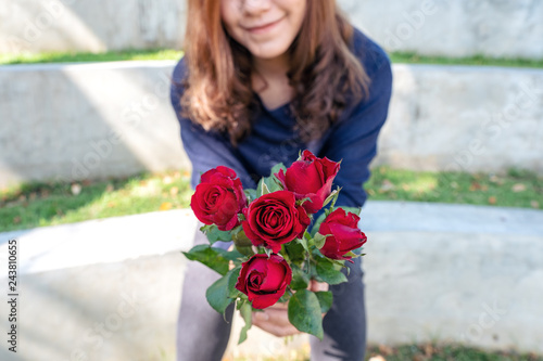 A Beautiful Asian Woman Giving Red Roses Flower To Her Boyfriend On Valentine S Day With Feeling Happy And Loved Stock Photo Adobe Stock