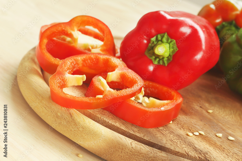 Red and green bell peppers on wooden cutting board. Red and green bell peppers on wooden cutting board.