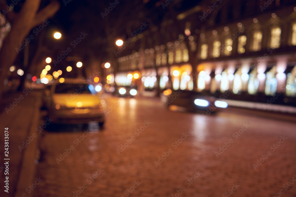 Background of blurred evening road with cars and lanterns