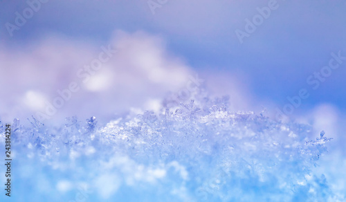  natural many crystals of snowflakes of various shapes and texture shimmer on sun on a clear winter day against a blue sky