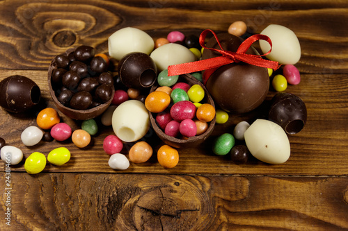 Easter composition with chocolate eggs on wooden background