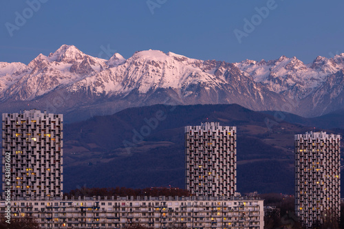 Grenoble, France, January 2019 : the three towers in front the belledonne mountains at sunset, ile verte neighbourhood © florent