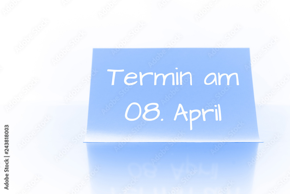 Termin am 8. April - blauer Zettel mit Notiz Termin am 8. April - blauer Zettel mit Notiz