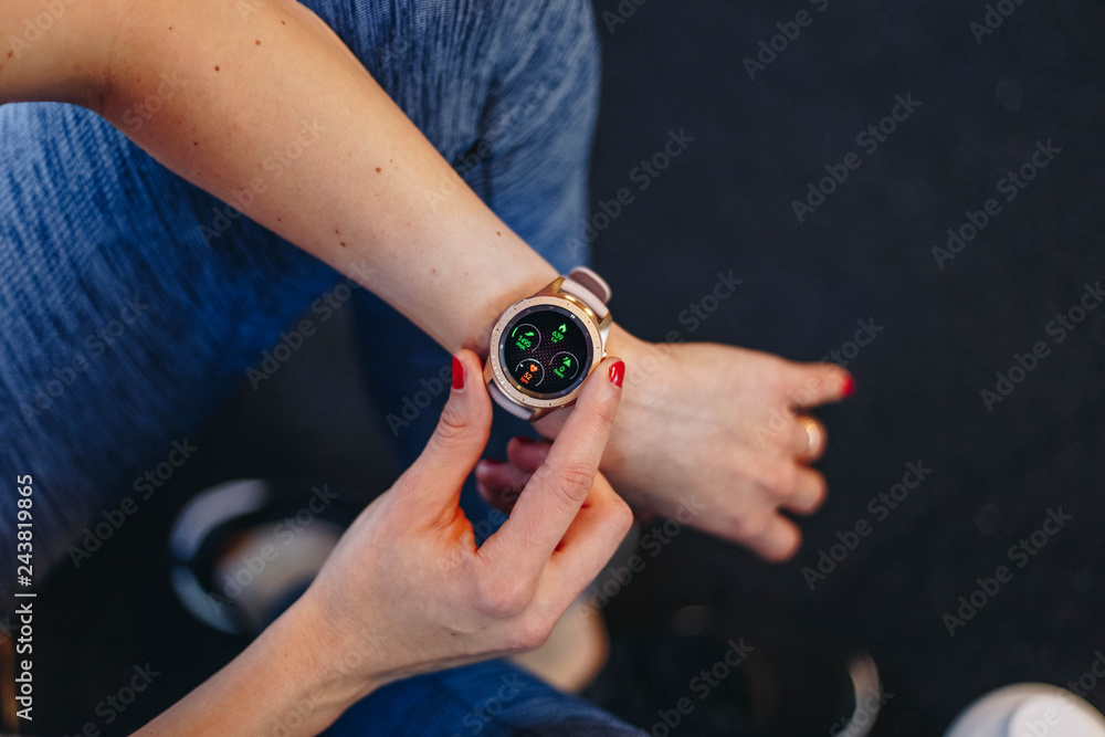 healthy lifestyle concept. fitness woman after workout session checks results on smartwatch in fitness app. detail of female athlete wearing sport tracker wristband arm healthy lifestyle concept. fitness woman after workout session checks results on smartwatch in fitness app. detail of female athlete wearing sport tracker wristband arm