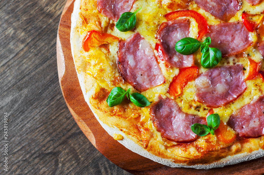 Pizza with Mozzarella cheese, ham, pepper, meat, Tomato sauce, Spices and Fresh Basil. Italian pizza on wooden background Pizza with Mozzarella cheese, ham, pepper, meat, Tomato sauce, Spices and Fresh Basil. Italian pizza on wooden background