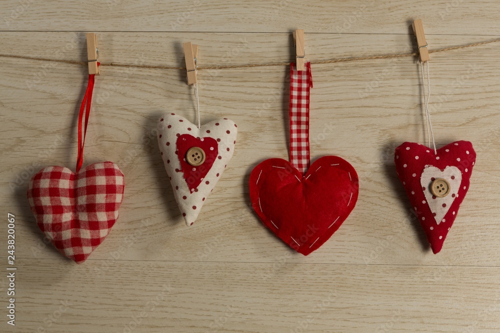 Fototapeta premium Heart shape decorations hanging on thread