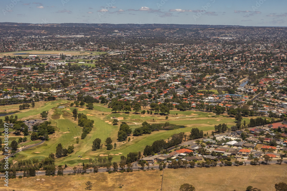 Taking Off  from Adelaides International Airport with a clear blue sky showing spectacular views of the city and its coastline.