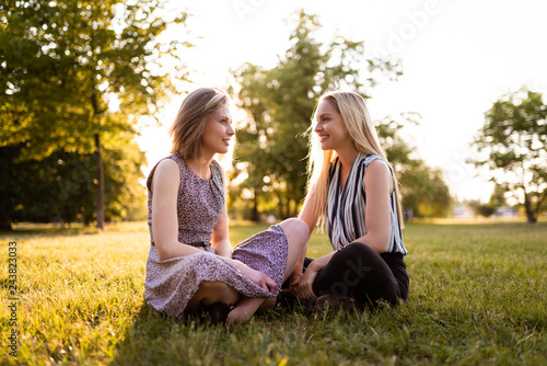 Best friends forever sitting together on grass