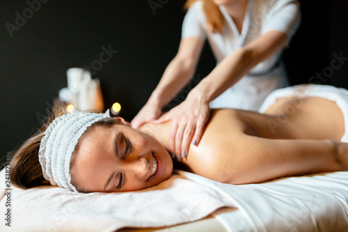 Massage therapist massaging woman