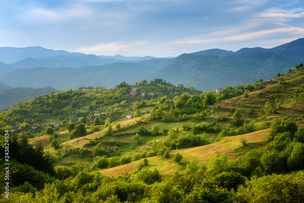 Spring is coming... Amazing spring view with a little village in Rhodopi Mountains, Bulgaria – Image. Magnificent landscape, green fields, small houses. Spring is coming... Amazing spring view with a little village in Rhodopi Mountains, Bulgaria – Image. Magnificent landscape, green fields, small houses.