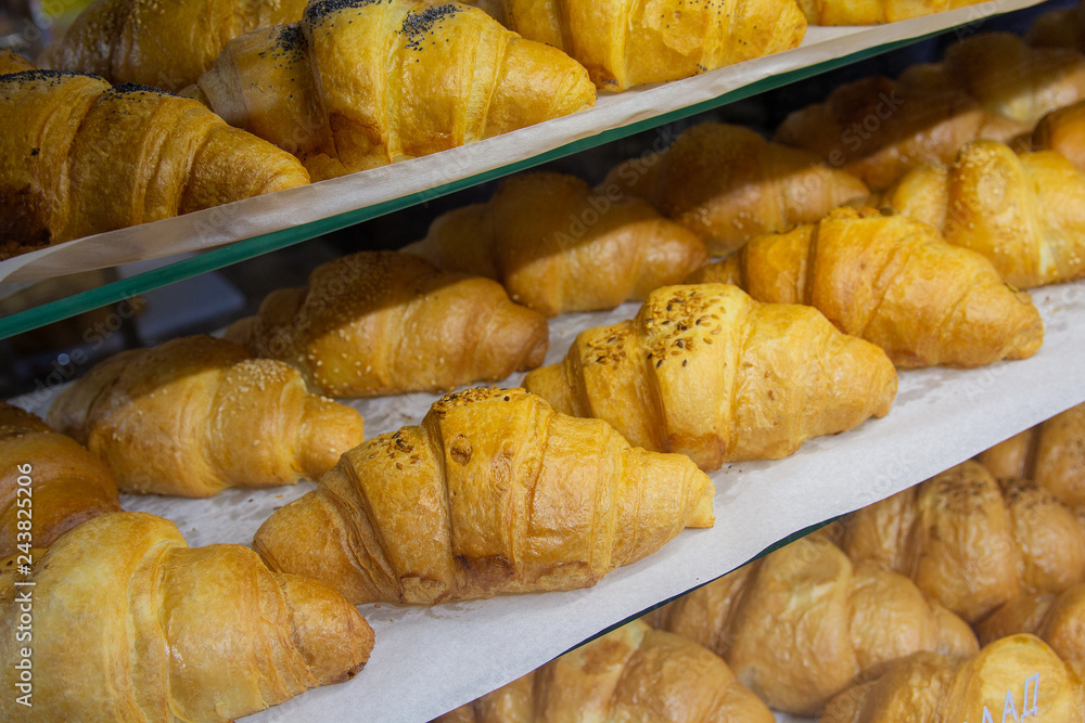 Delicious croissants on the store showcase of the bakery house Delicious croissants on the store showcase of the bakery house