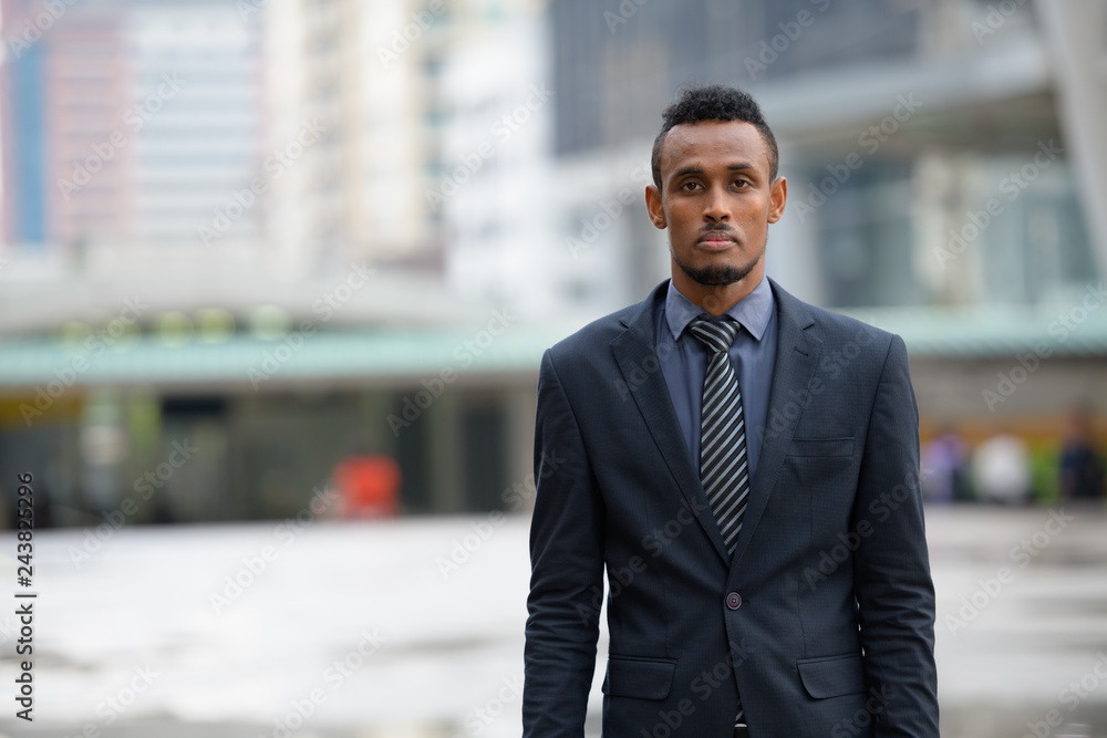 Young African businessman in the city streets outdoors Young African businessman in the city streets outdoors