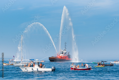Fire brigade ship with high splashes to the sky