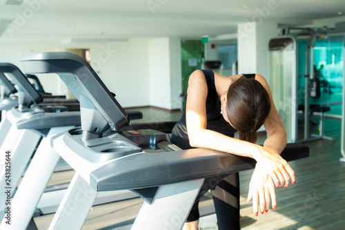 girl is bored and sad in the sport on the treadmill