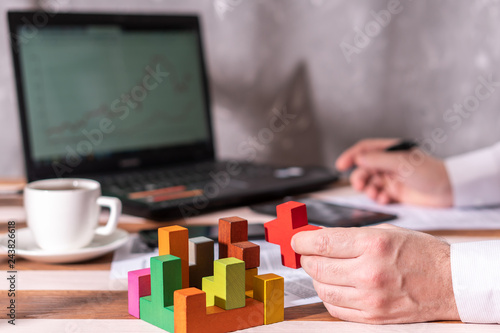 Foto Businessman with conundrum at table in office.