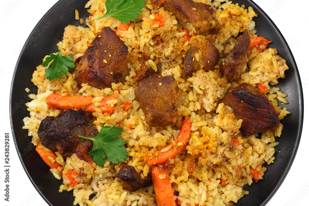 pilaf with meat on black plate isolated on white background. top view pilaf with meat on black plate isolated on white background. top view