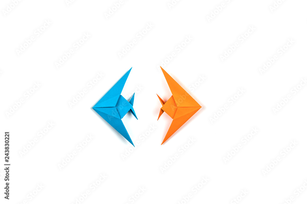 Two origami fishes isolated on white background. Two origami fishes isolated on white background.
