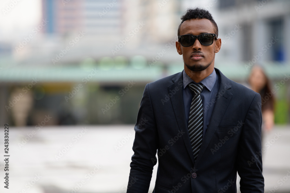 Young African businessman wearing sunglasses in the city outdoors