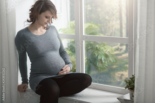 Free Download Young pregnant woman relaxing at home - GFXLoad
