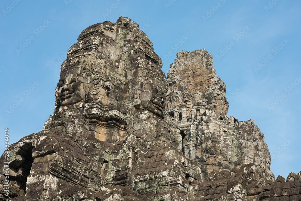 Siem Reap,Cambodia-Januay 11, 2019: Bodhisattva face towers viewed near the east gate of Bayon, Angkor Thom, Siem Reap Siem Reap,Cambodia-Januay 11, 2019: Bodhisattva face towers viewed near the east gate of Bayon, Angkor Thom, Siem Reap