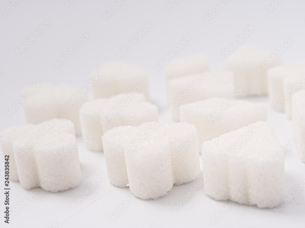white lump sugar refined on a white background. white lump sugar refined on a white background.