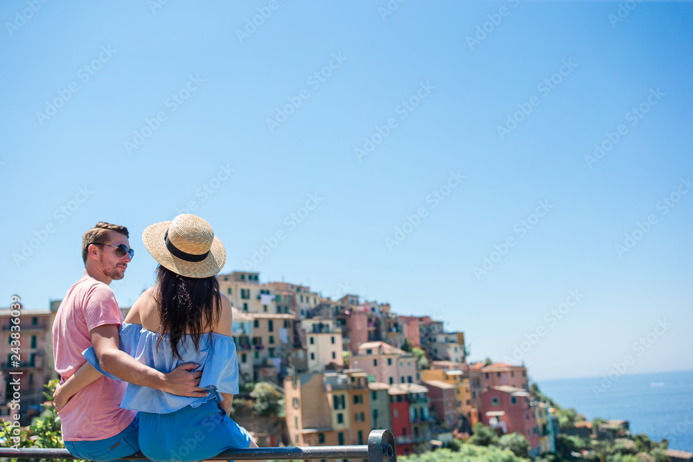 Happy family with view of the old coastal town background of Vernazza, Cinque Terre national park, Liguria, Italy