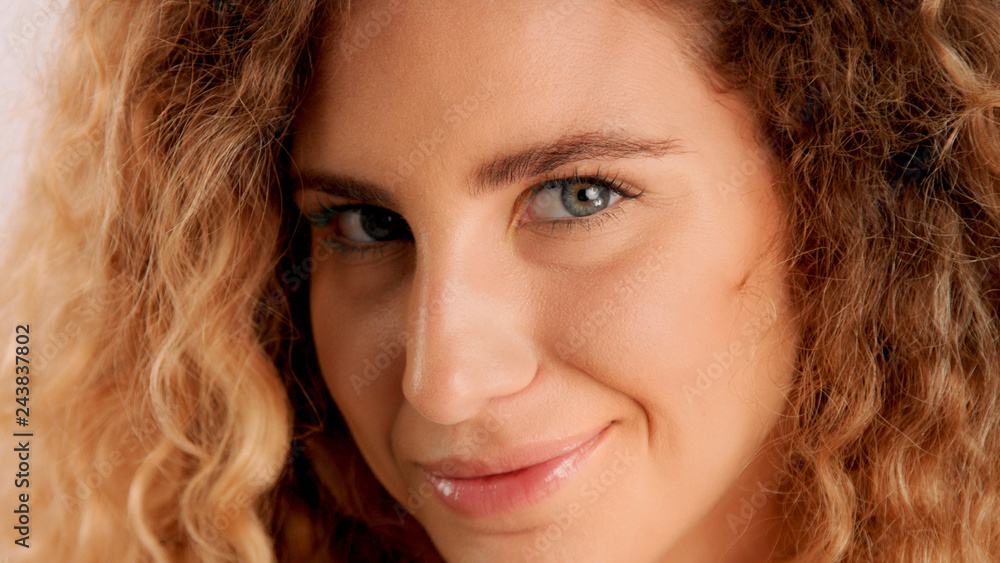 happy smiling, flirty glance closeup portrait of blonde model with ideal skin and cyrly hair happy smiling, flirty glance closeup portrait of blonde model with ideal skin and cyrly hair
