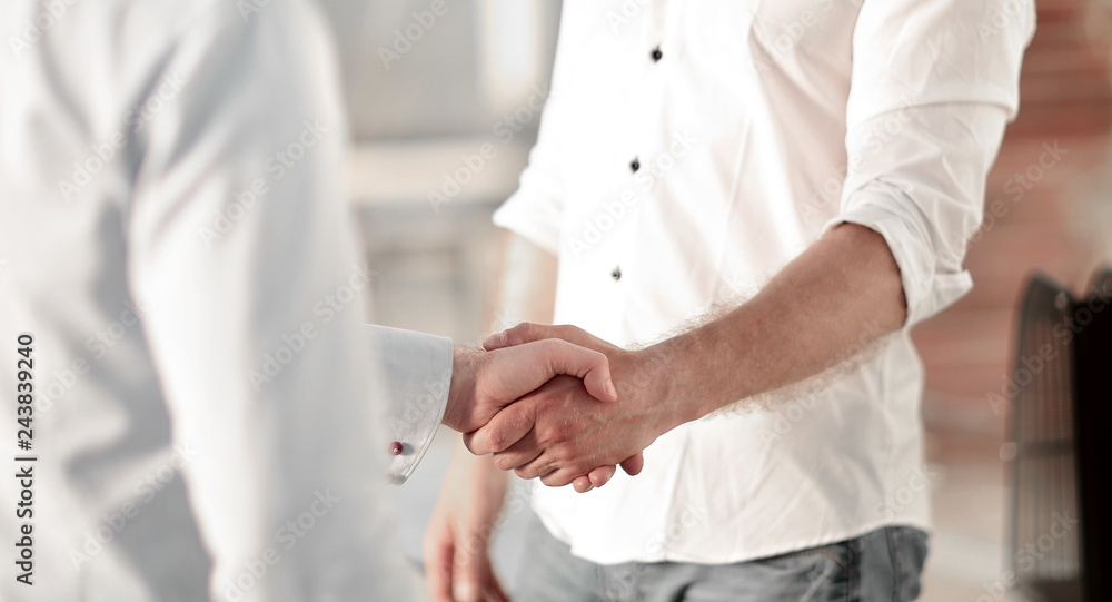 handshake of business people standing in a creative office
