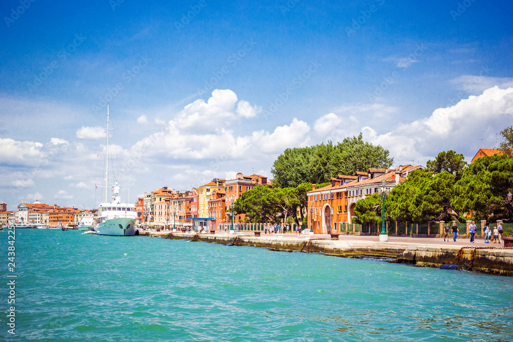 Panoramic view of Venice from Grand Canal to embankment of city with moored ships, Venice, Italy
