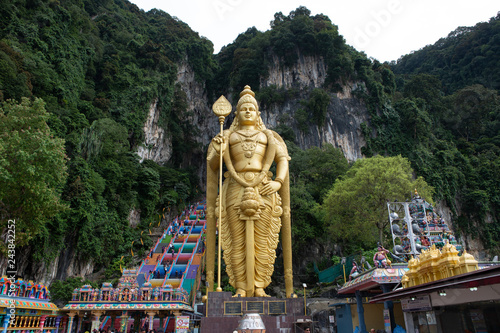 The Batu Caves Lord Murugan Statue and entrance near Kuala Lumpur Malaysia. A limestone outcrop located just north of Kuala Lumpur, Batu Caves has three main caves featuring temples and Hindu shrines.