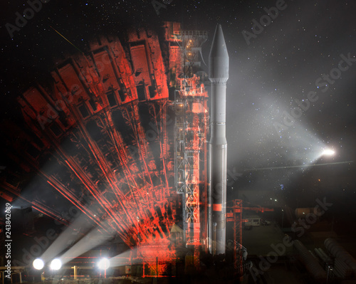 Missile launch preparation prelaunch at night, illumination from spotlights and Illusion of multiple rocker arms. The elements of this image furnished by NASA. photo