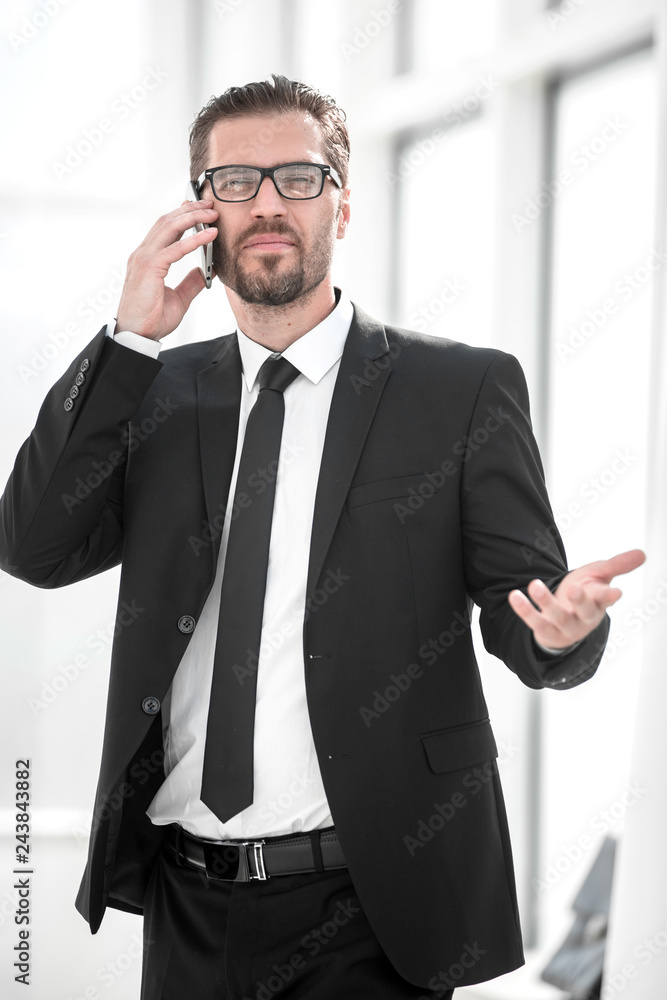businessman talking to a business partner in a cell phone businessman talking to a business partner in a cell phone