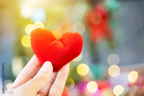 Red heart on hand with blurred light background. Love  wedding and valentine concept.