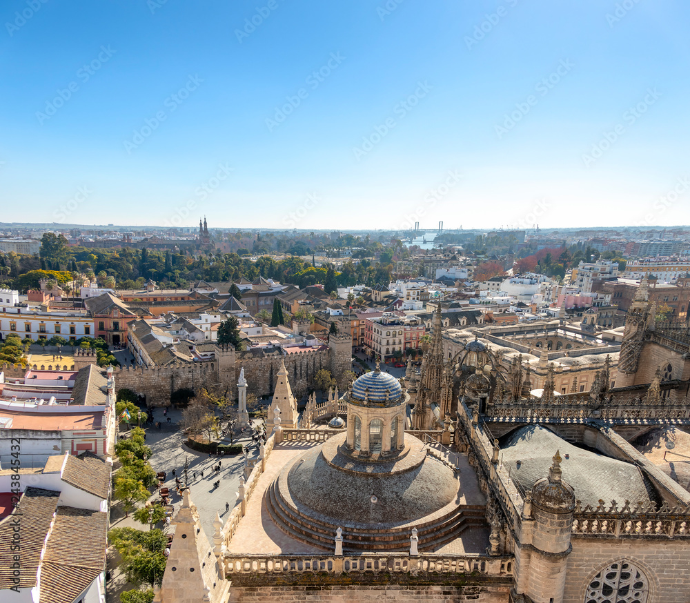 Aerial view of Seville city and Cathedral of Saint Mary of the See in Seville as seen from seen from the Giralda tower. With Royal Alcázar of Seville and The Plaza de España 