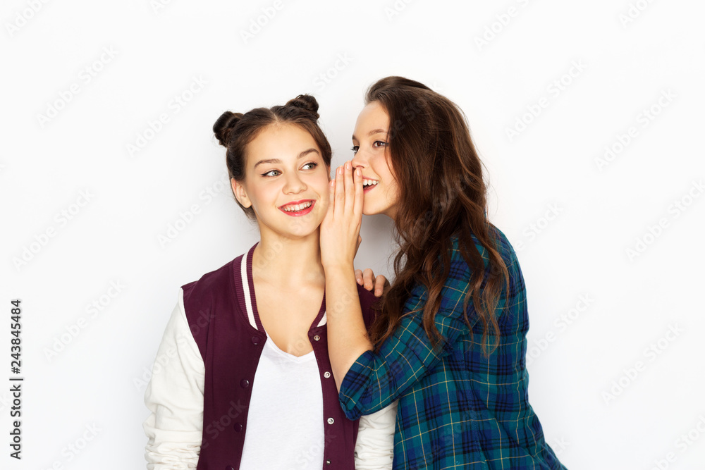 friendship, communication and people concept - happy teenage girls gossiping or sharing secrets over white background friendship, communication and people concept - happy teenage girls gossiping or sharing secrets over white background