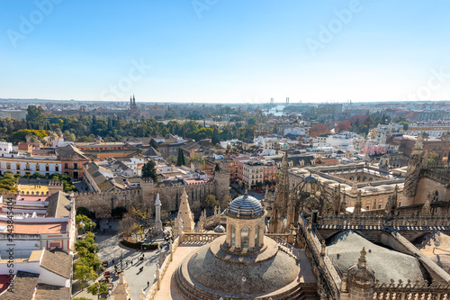 Aerial view of Seville city and Cathedral of Saint Mary of the See in Seville as seen from seen from the Giralda tower. With Royal Alcázar of Seville and The Plaza de España "Spain Square"