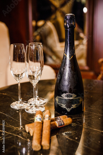 wine and cuban cigars are on the table