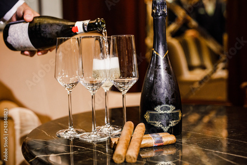 wine and cuban cigars are on the table